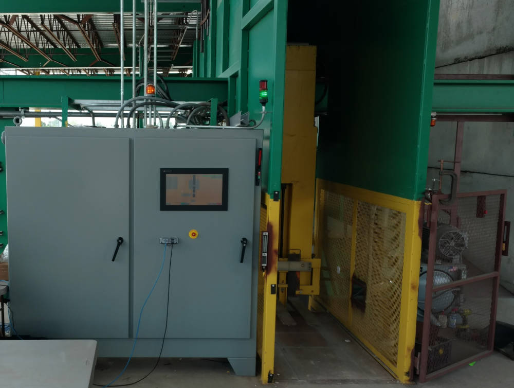Figure 1: The front view of the control panel and cart lift during the late stages of construction. The primary operator interface is on the front of the control panel. The Richard S. Burns & Company Tommy Carts are rolled into the lift, weighed, lifted, then dumped onto the conveyor behind the lift. A ControlLogix PLC from Rockwell Automation controls the process and helps with communications. A predesigned Softing SQL gateway module interfaced with the SQL to provide diagnostics. Courtesy: Cornerstone Automation 